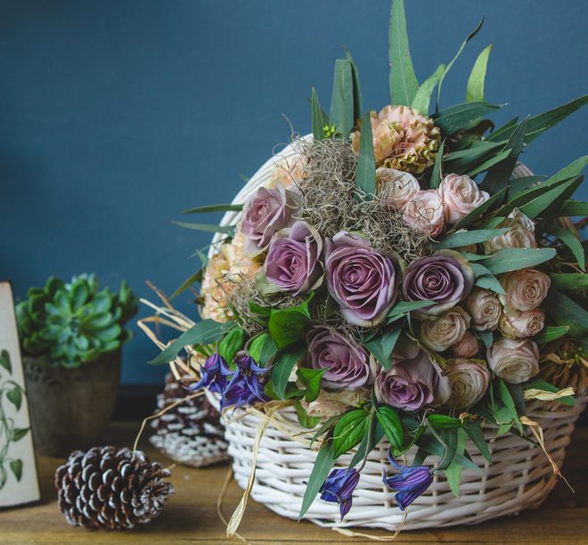 Pastel-toned spray rose mix in a wicker basket